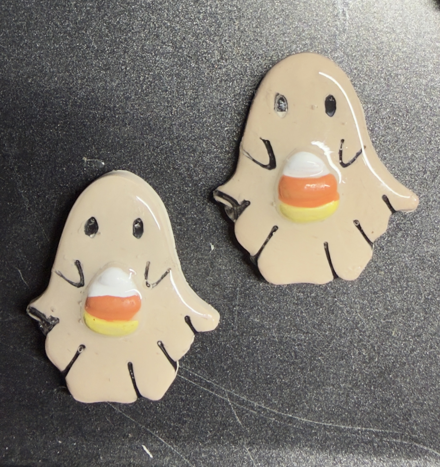 Ghosts holding candy corn